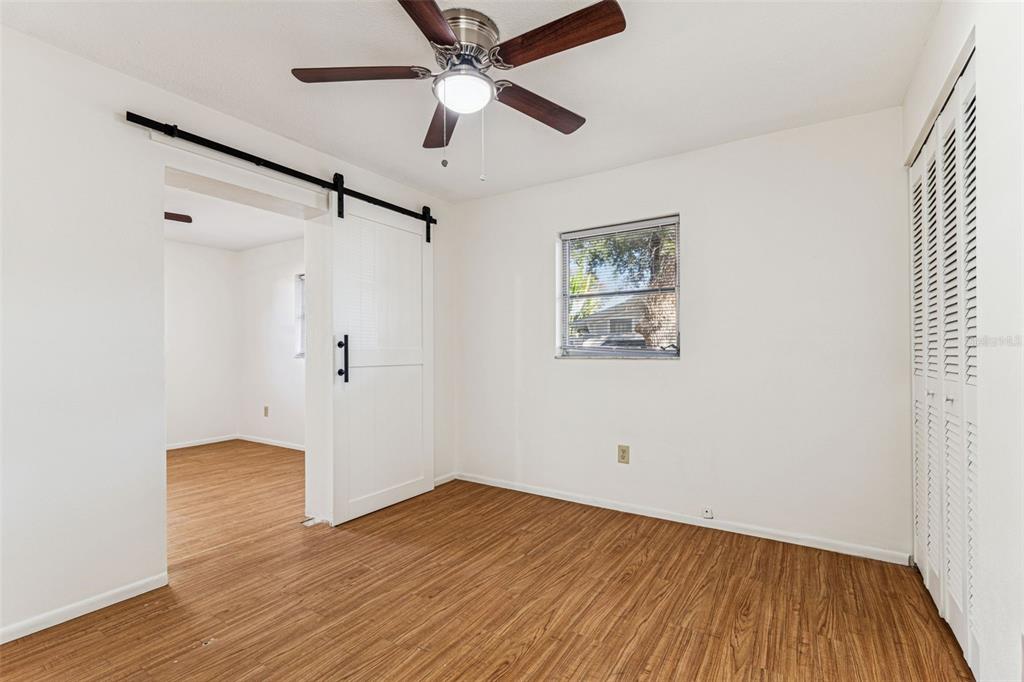 822 3rd Avenue Northwest Largo, FL 33770 - Photo 37 of 75 an empty room with wooden floor and windows