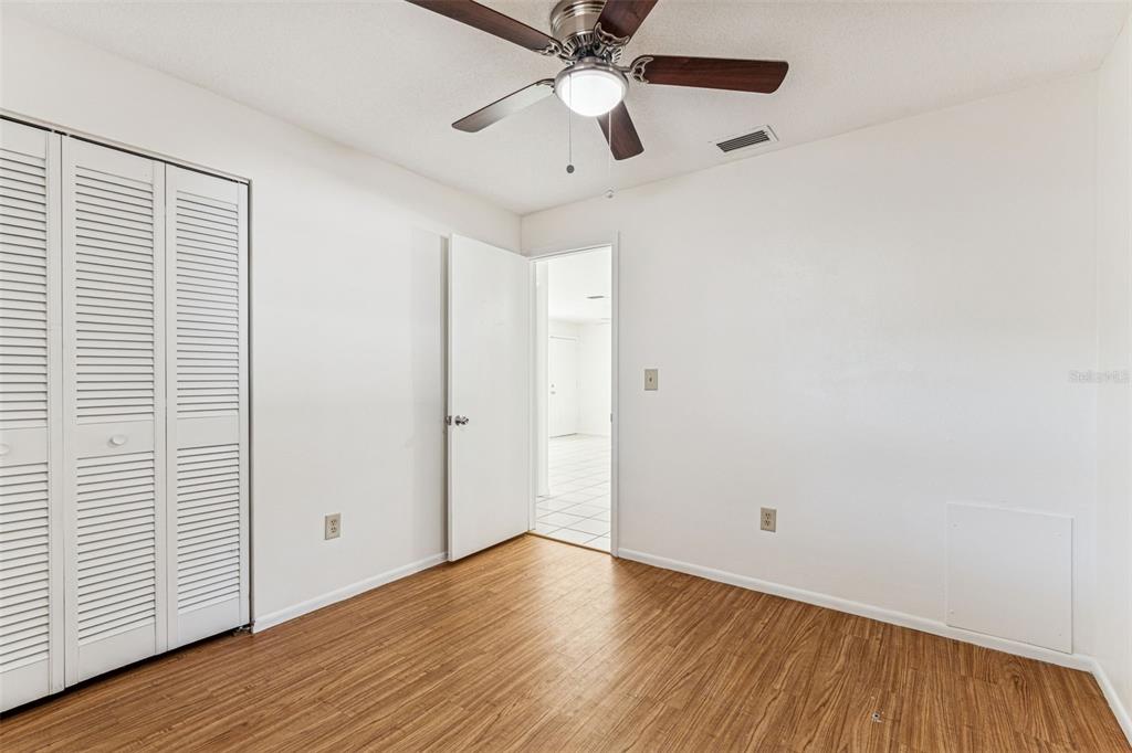 822 3rd Avenue Northwest Largo, FL 33770 - Photo 40 of 75 a view of an empty room with wooden floor and a ceiling fan