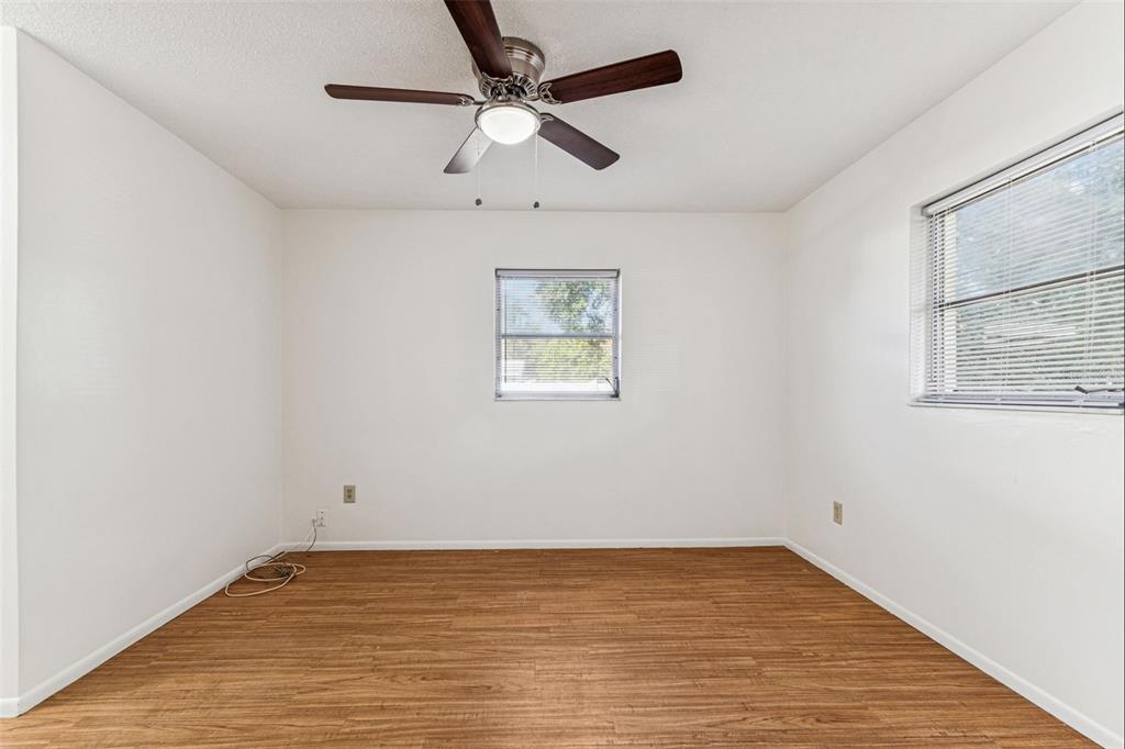 822 3rd Avenue Northwest Largo, FL 33770 - Photo 42 of 75 an empty room with a window and a ceiling fan