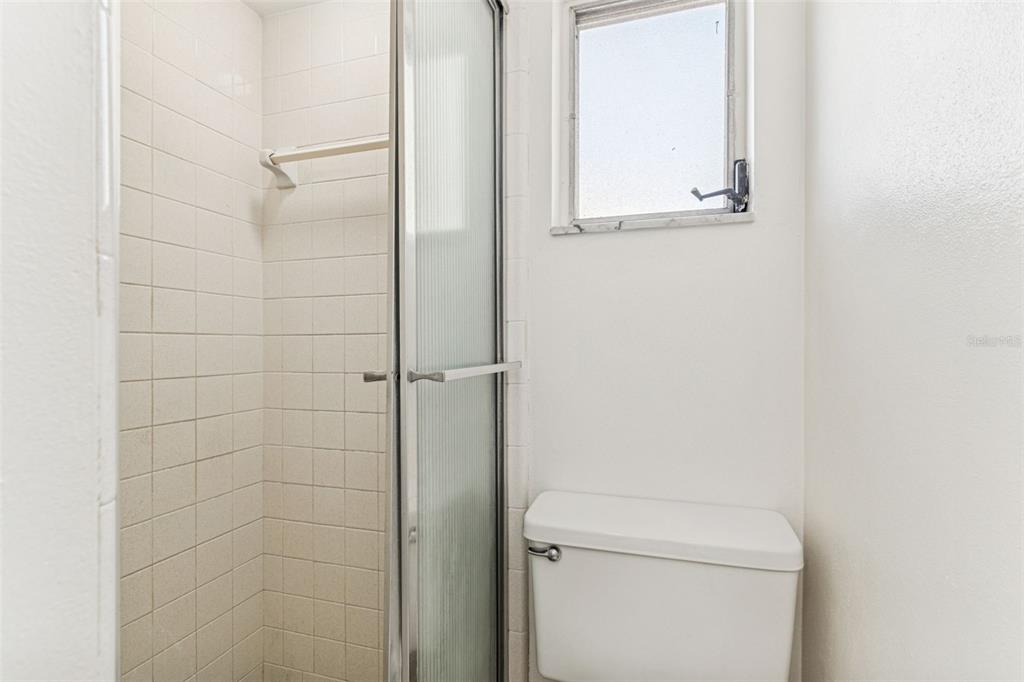 822 3rd Avenue Northwest Largo, FL 33770 - Photo 49 of 75 a bathroom with a toilet and a shower