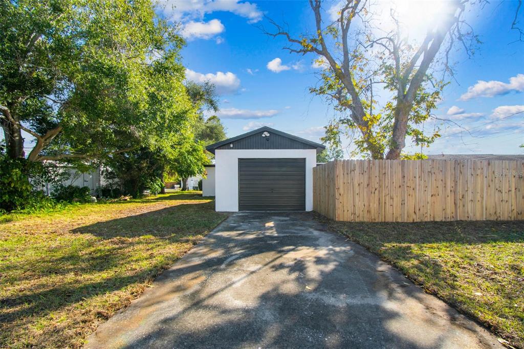822 3rd Avenue Northwest Largo, FL 33770 - Photo 68 of 75 a front view of a house with a yard and garage