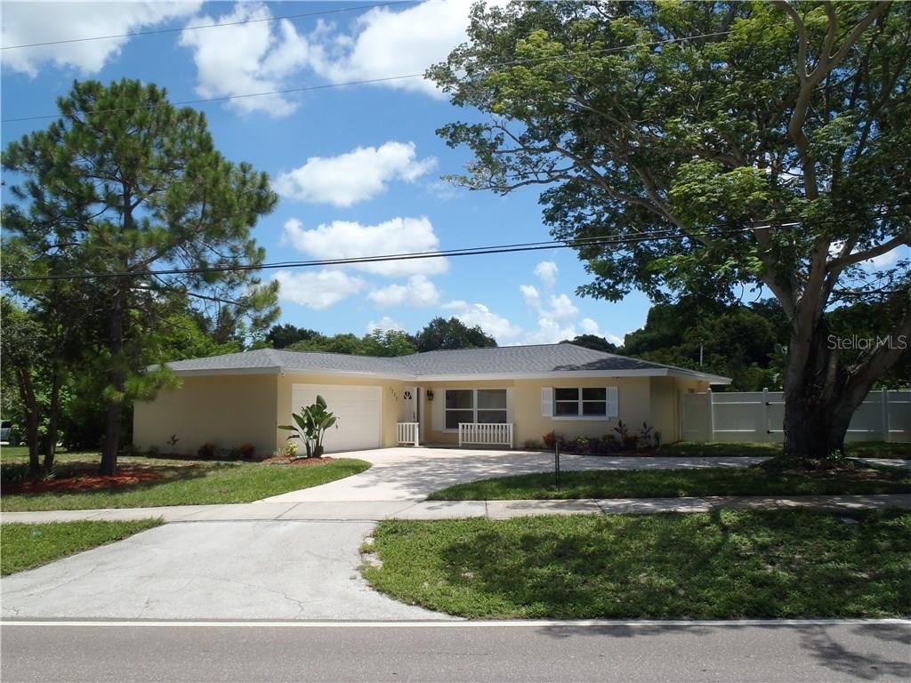1773 Pinehurst Road Dunedin, FL 34698 - Photo 1 of 1 a front view of a house with a garden