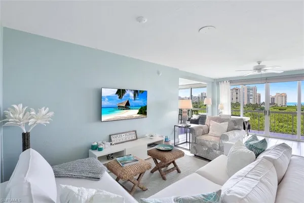 a living room with furniture flowerpot and window