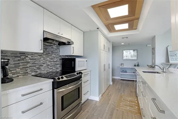 a kitchen with a sink appliances and cabinets