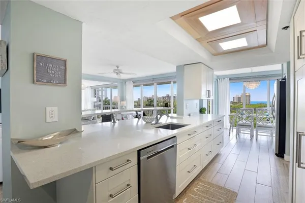 a kitchen with sink cabinets and living room