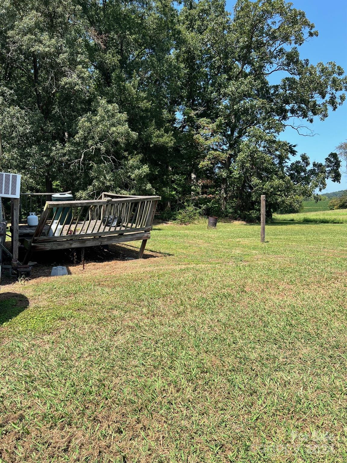 414 Drye Road Polkton, NC 28135 - Photo 12 of 12 a view of swimming pool with lawn chairs and large trees