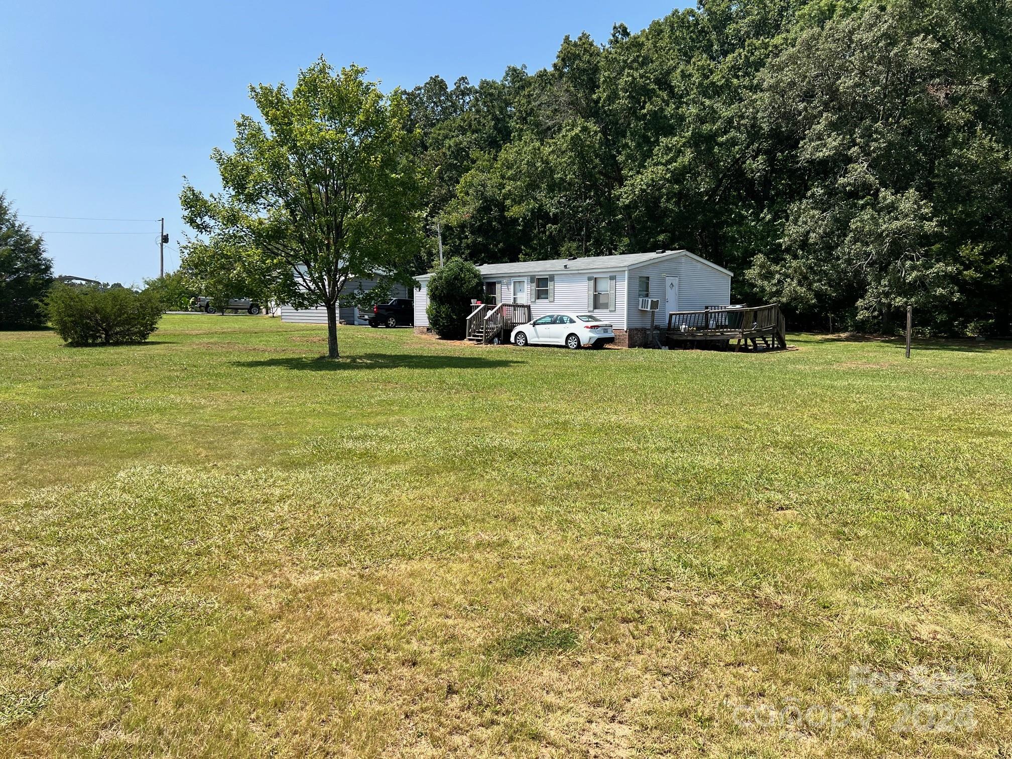 414 Drye Road Polkton, NC 28135 - Photo 2 of 12 a front view of a house with a yard and trees