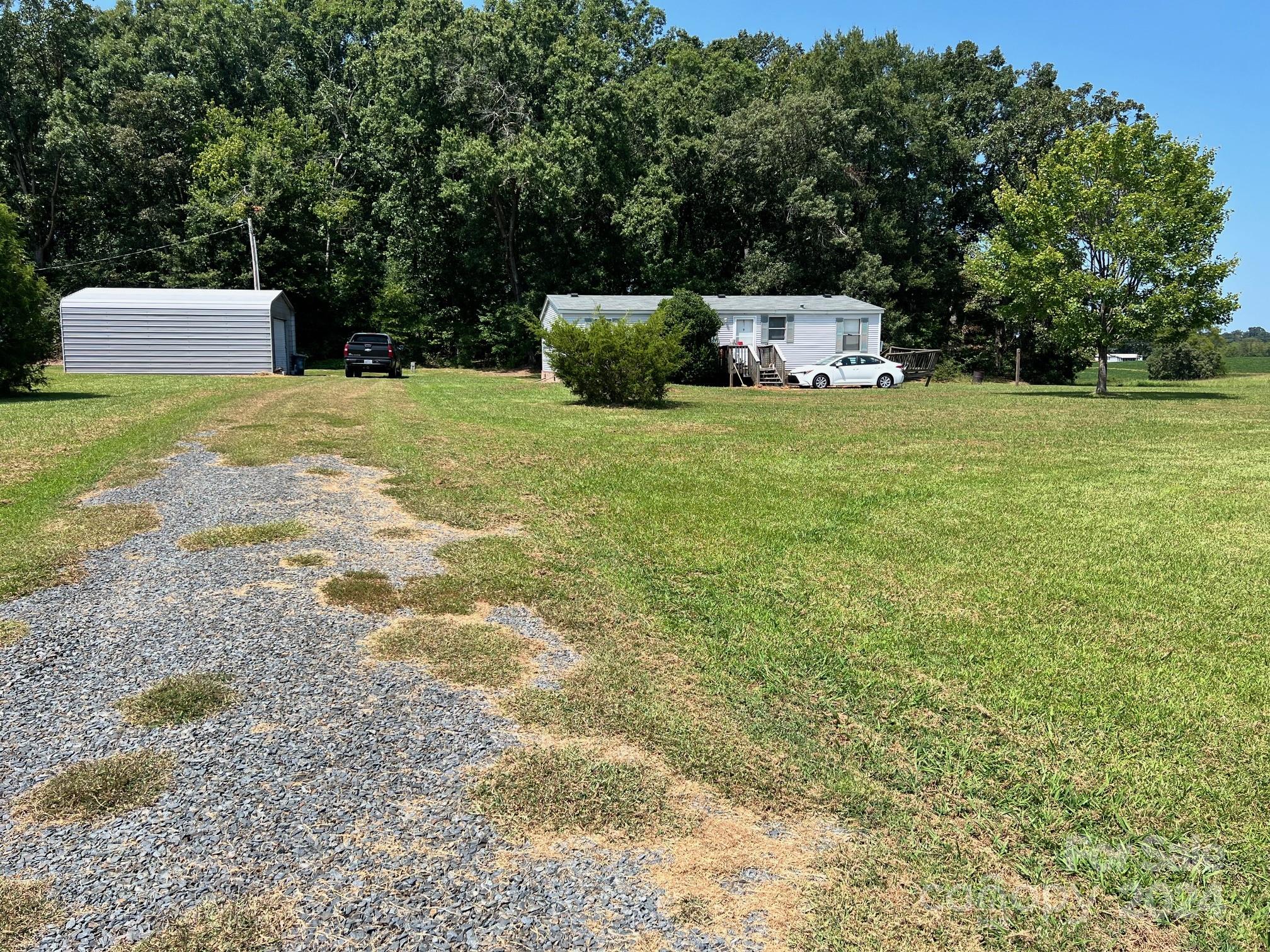 414 Drye Road Polkton, NC 28135 - Photo 3 of 12 a view of a white house with a yard