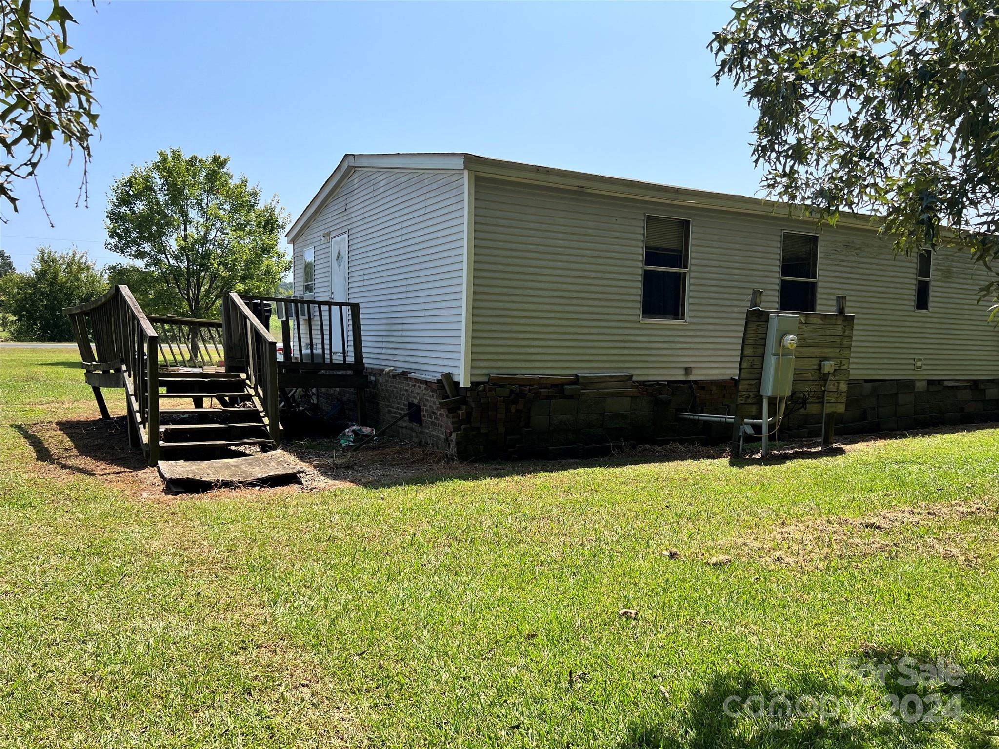 414 Drye Road Polkton, NC 28135 - Photo 8 of 12 a backyard of a house with wooden fence and a large tree