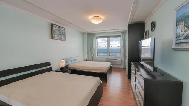 a bedroom with a bed and a flat screen tv