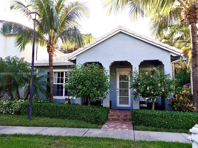 a kitchen with stainless steel appliances a sink a stove a refrigerator a counter top space and cabinets