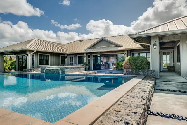 a large bedroom with a bed and large window