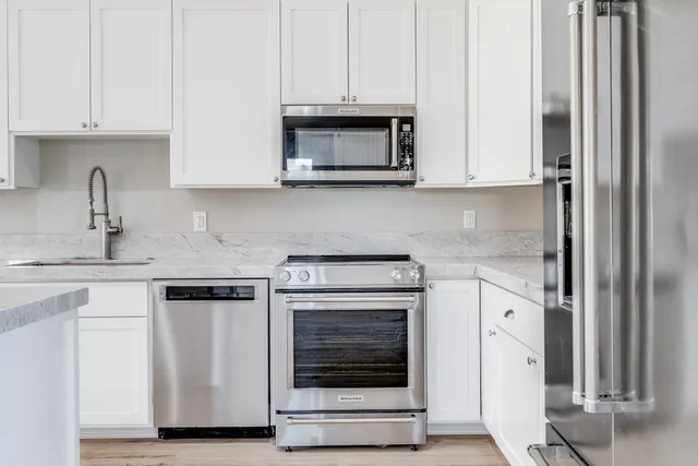 a kitchen with cabinets a sink and appliances