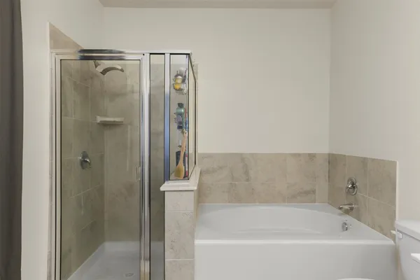 a bathroom with a bathtub and a shower