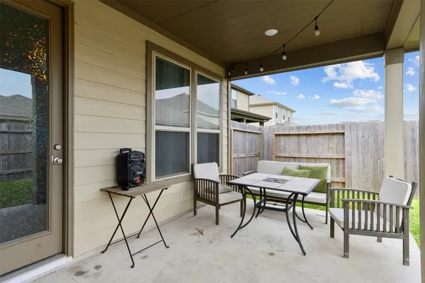 a view of a patio with a table and chairs