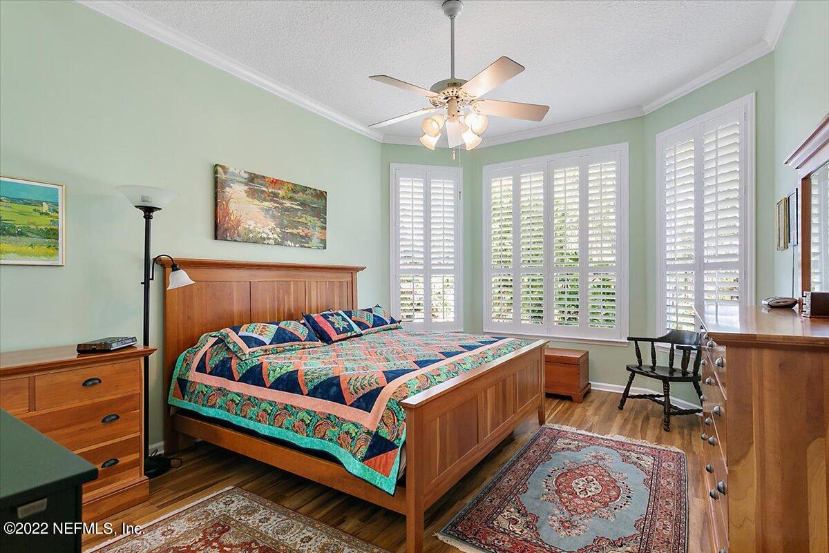 184 Edge Of Woods Road St. Augustine, FL 32092 - Photo 12 of 24 a bed sitting in a bedroom next to a window