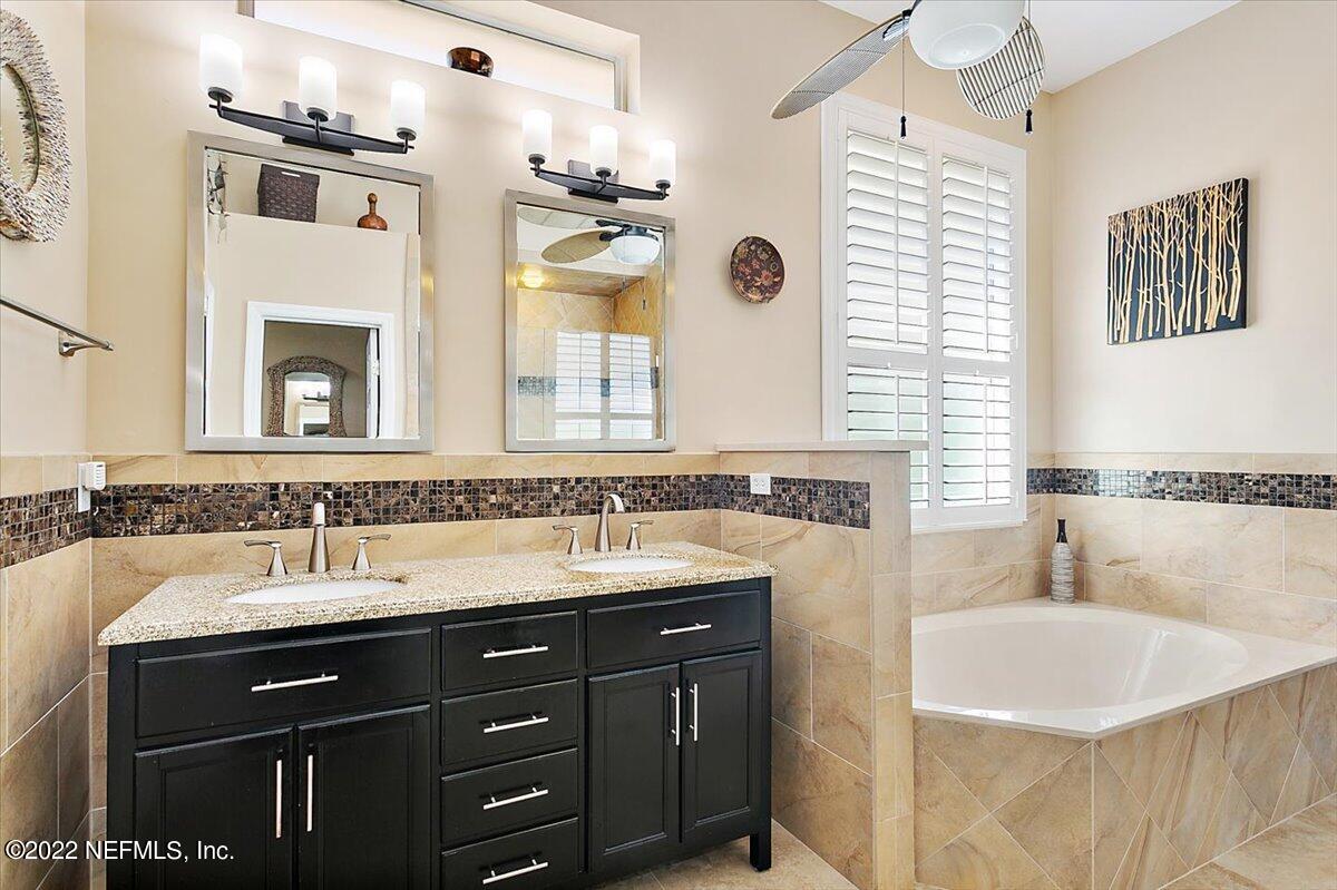184 Edge Of Woods Road St. Augustine, FL 32092 - Photo 13 of 24 a bathroom with a sink double vanity and a bathtub