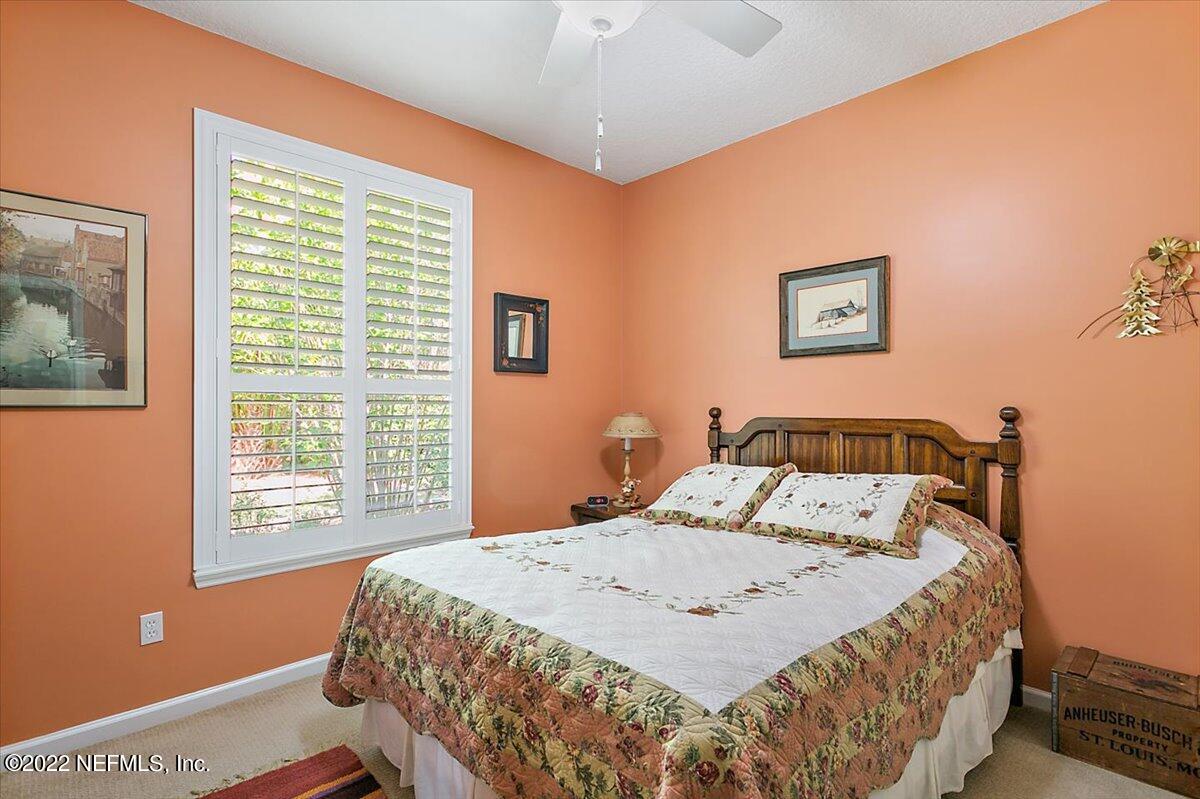 184 Edge Of Woods Road St. Augustine, FL 32092 - Photo 15 of 24 a bed sitting in a bedroom next to a window