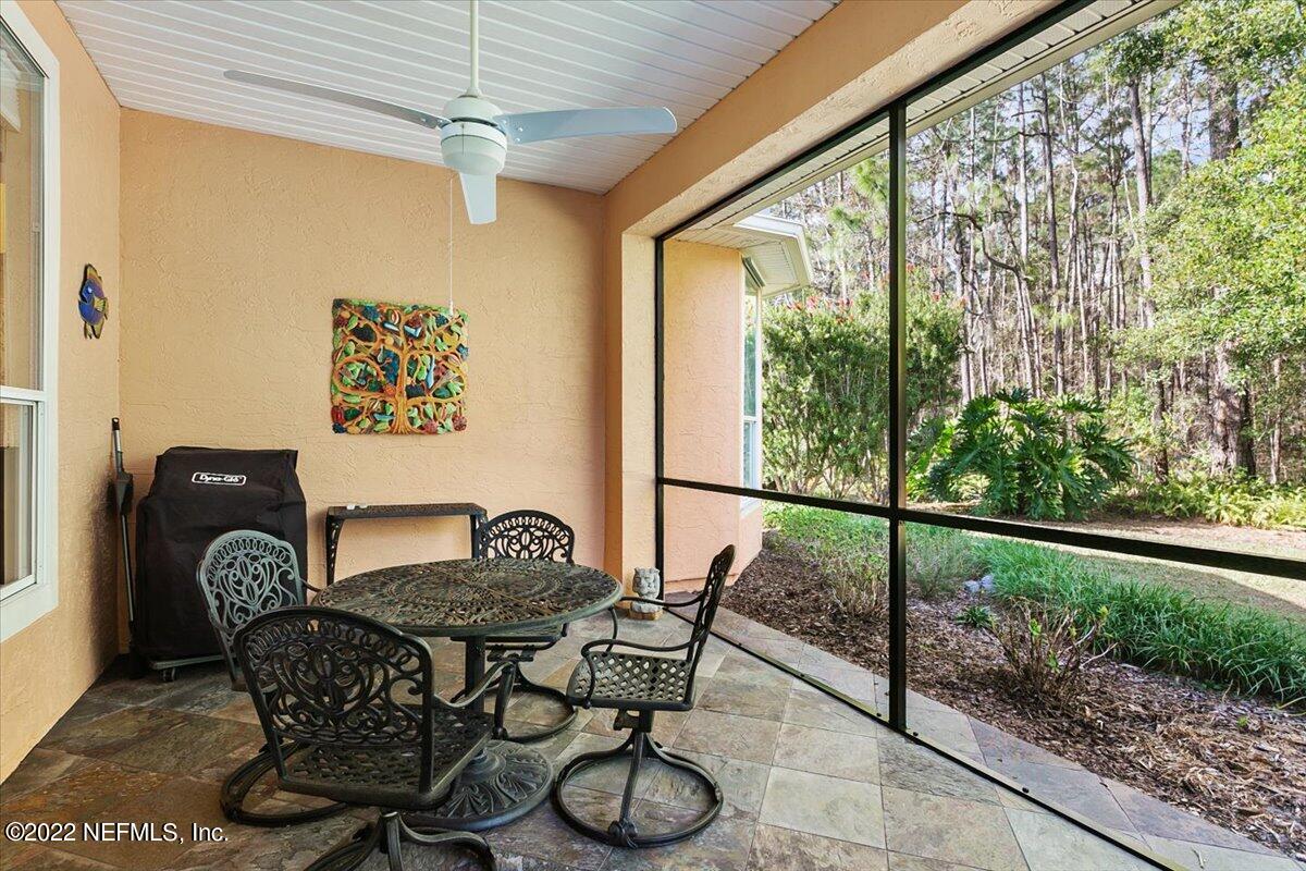 184 Edge Of Woods Road St. Augustine, FL 32092 - Photo 19 of 24 a dining room with furniture and a floor to ceiling window