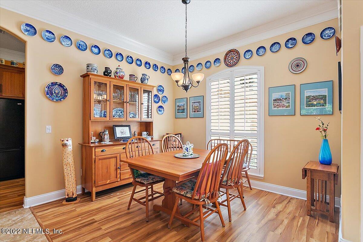 184 Edge Of Woods Road St. Augustine, FL 32092 - Photo 4 of 24 a dining room with furniture and wooden floor