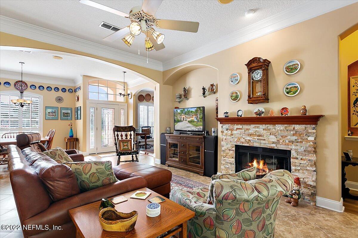 184 Edge Of Woods Road St. Augustine, FL 32092 - Photo 7 of 24 a living room with furniture and a fireplace