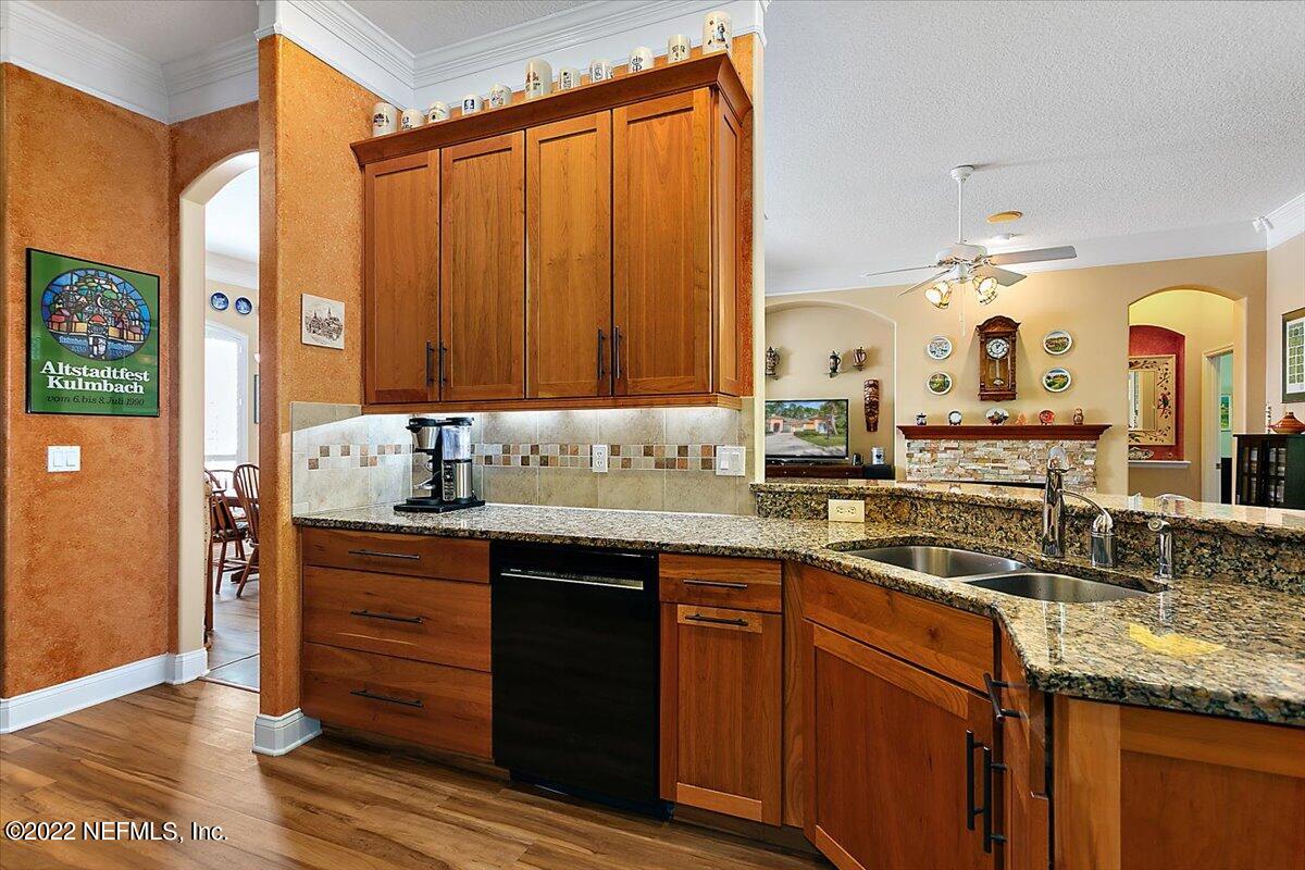 184 Edge Of Woods Road St. Augustine, FL 32092 - Photo 9 of 24 a kitchen with granite countertop a sink and cabinets