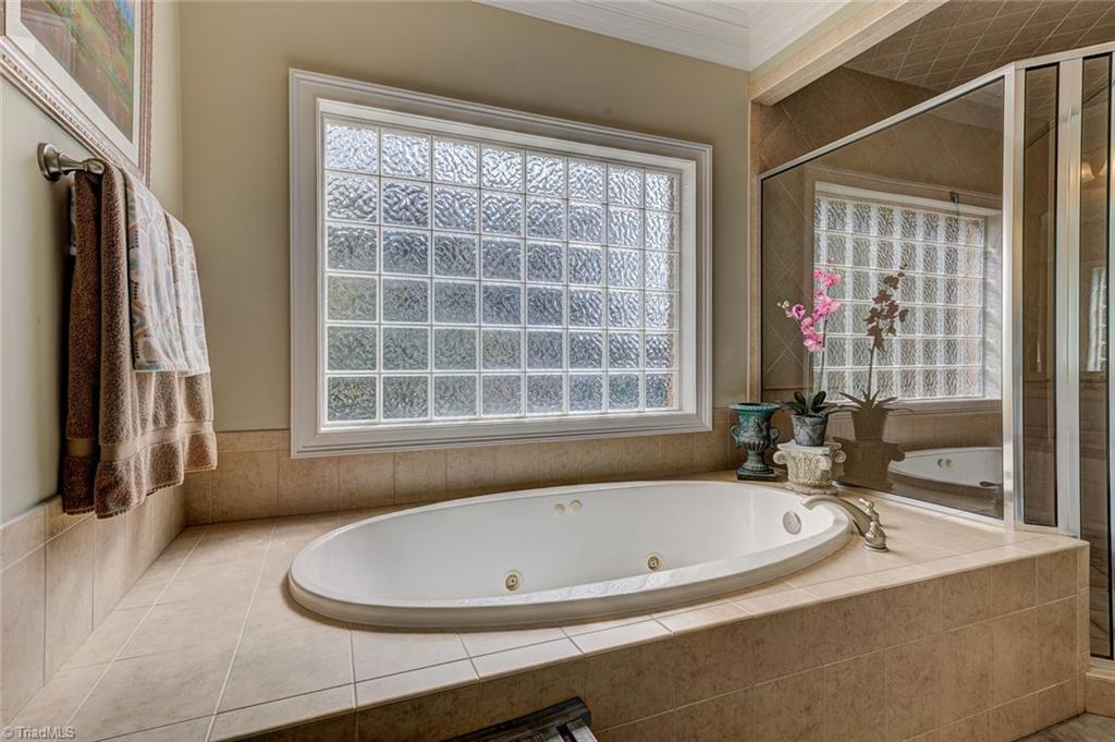 122 Augusta Place High Point, NC 27265 - Photo 17 of 30 Relax after a long day in the jetted tub with tile detail.