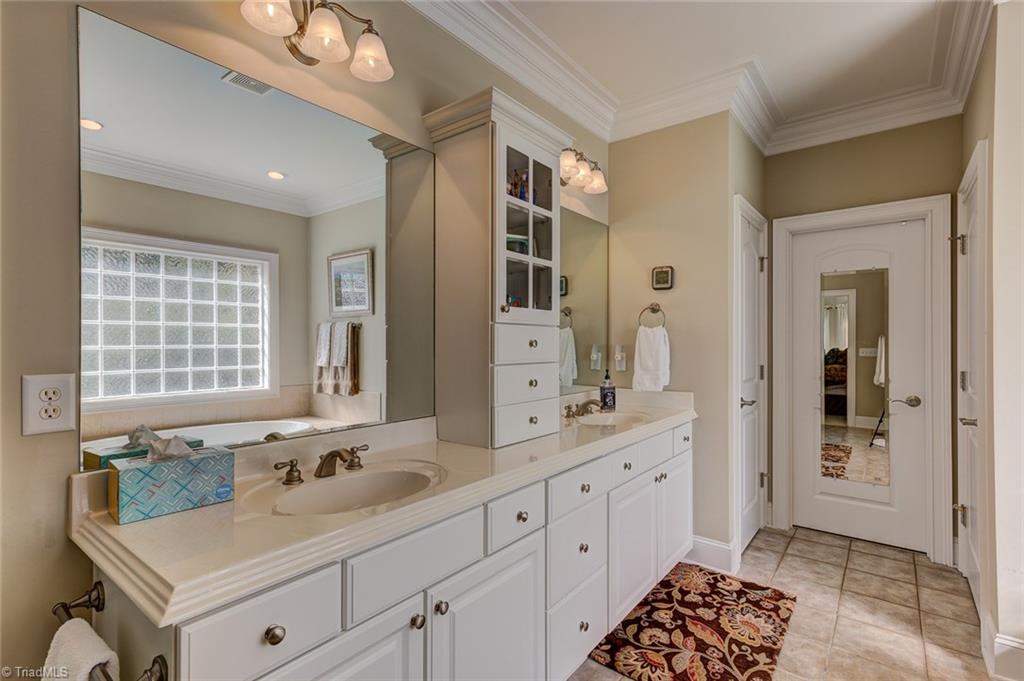122 Augusta Place High Point, NC 27265 - Photo 19 of 30 Dual vanities with ample cabinet storage in the master bath offer you plenty of room for storage.