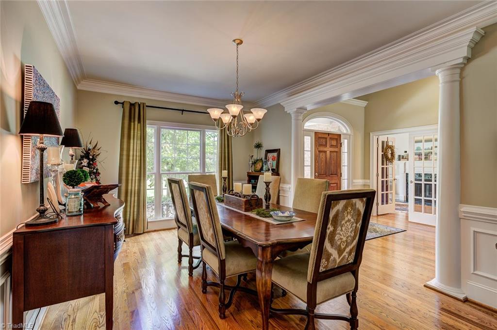 122 Augusta Place High Point, NC 27265 - Photo 3 of 30 The formal dining room receives ample sunlight from a large window. Elegant wainscoting and crown molding details make this a lovely room for entertaining.