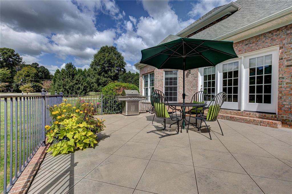 122 Augusta Place High Point, NC 27265 - Photo 28 of 30 The spacious back patio features a wrought iron railing and concrete base and offers a lovely view.