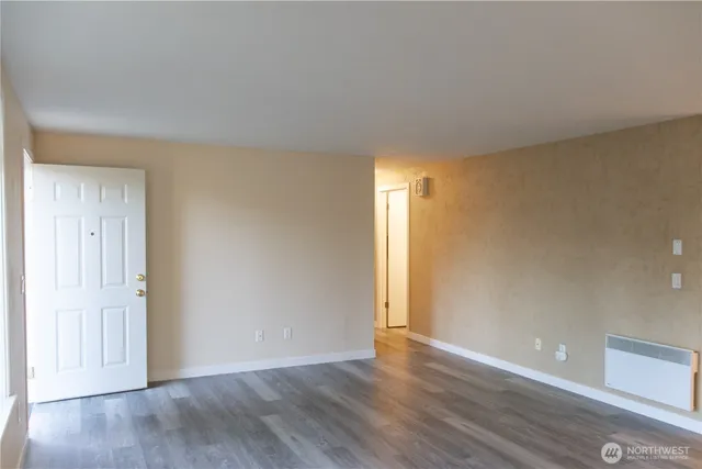a view of an empty room and wooden floor