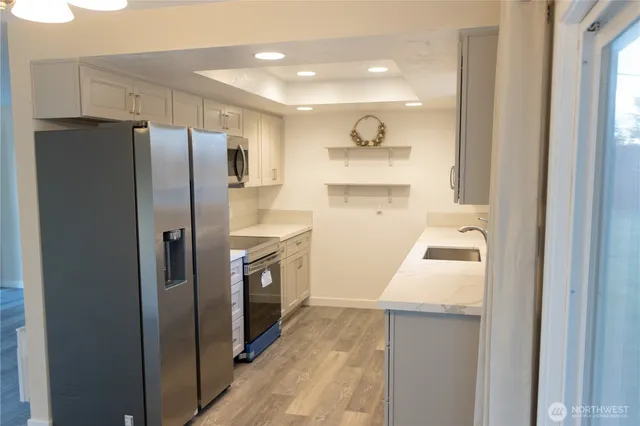a kitchen with a refrigerator a sink and dishwasher
