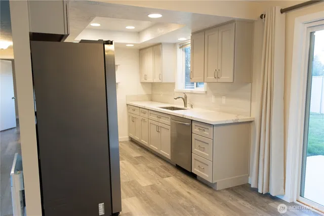 a kitchen with a sink cabinets and stainless steel appliances