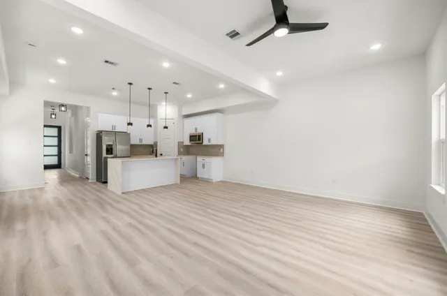 a view of kitchen with furniture and refrigerator
