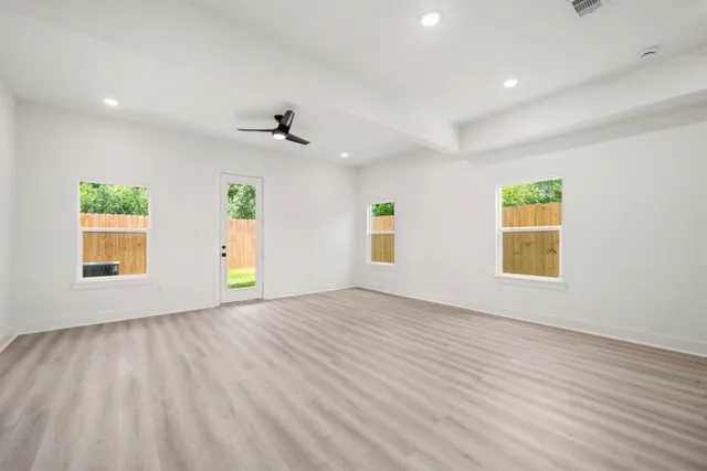 wooden floor in an empty room with a window