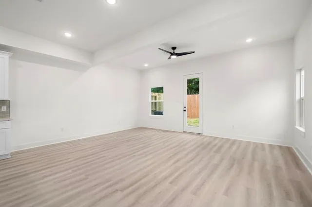 wooden floor in an empty room with a window