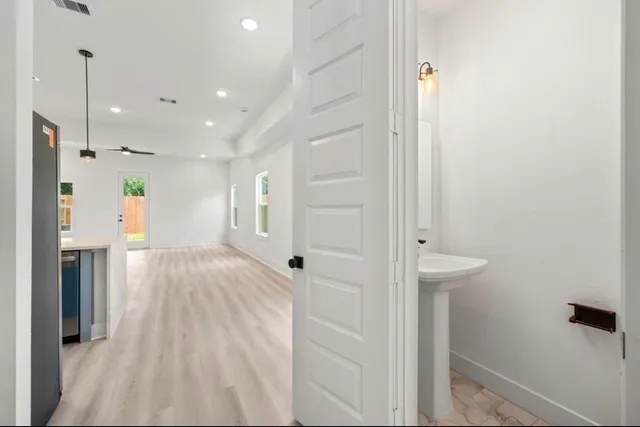 a view of hallway with wooden floor