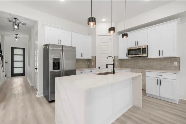 a kitchen with refrigerator and stove