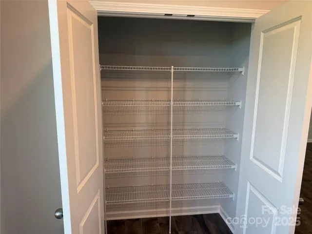 a kitchen with a window wooden floor