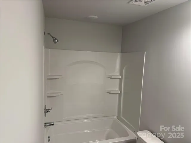 a bathroom with a sink vanity and toilet