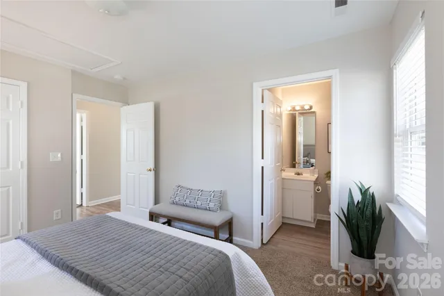 a bedroom with a bed and a potted plant