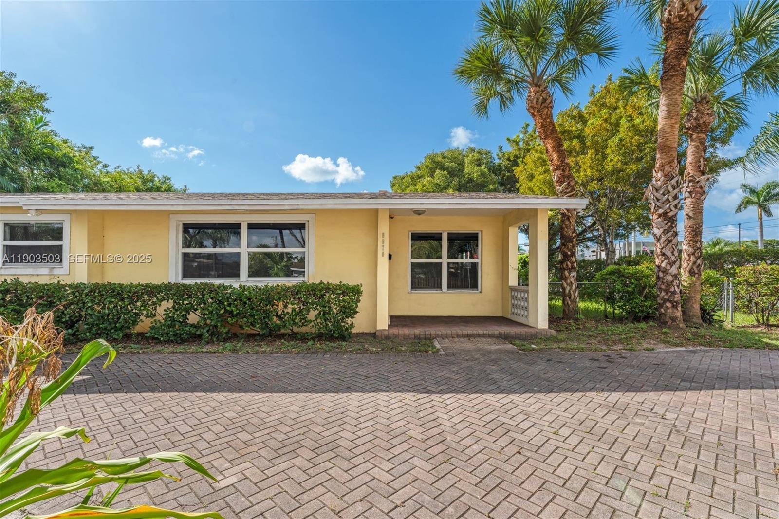 8670 Southwest 27th Lane Miami, FL 33155 - Photo 1 of 31 a front view of a house with a yard and potted plants