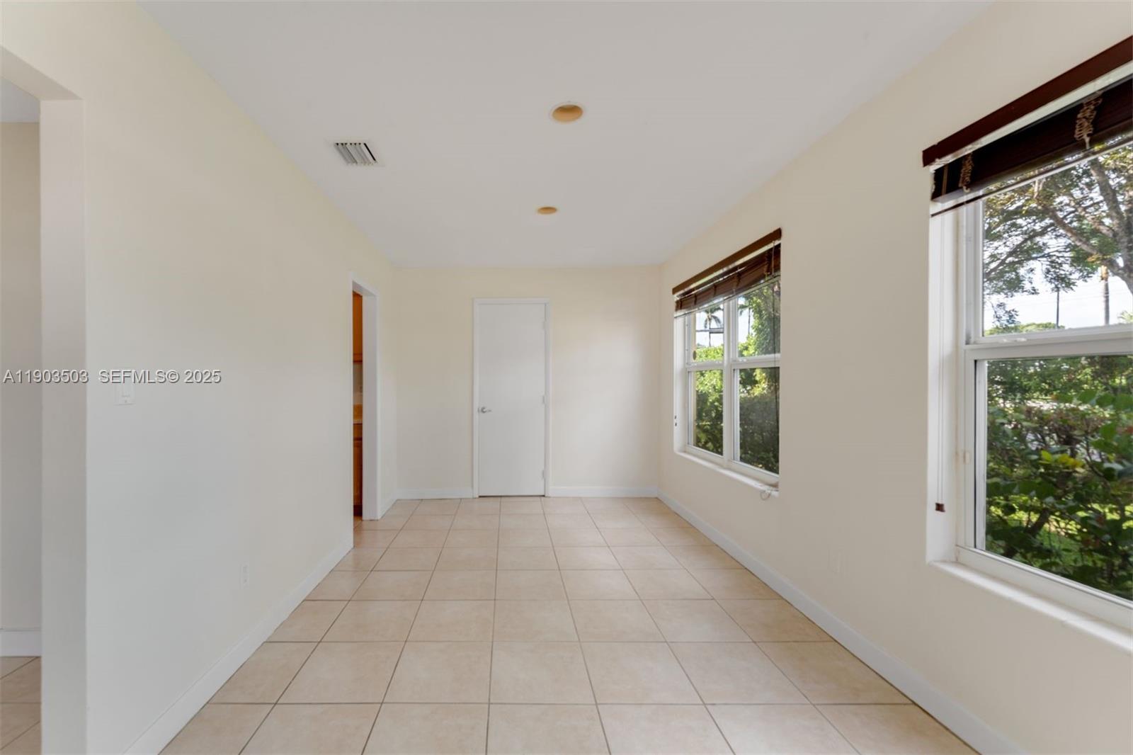 8670 Southwest 27th Lane Miami, FL 33155 - Photo 13 of 31 a view of an empty room with a window