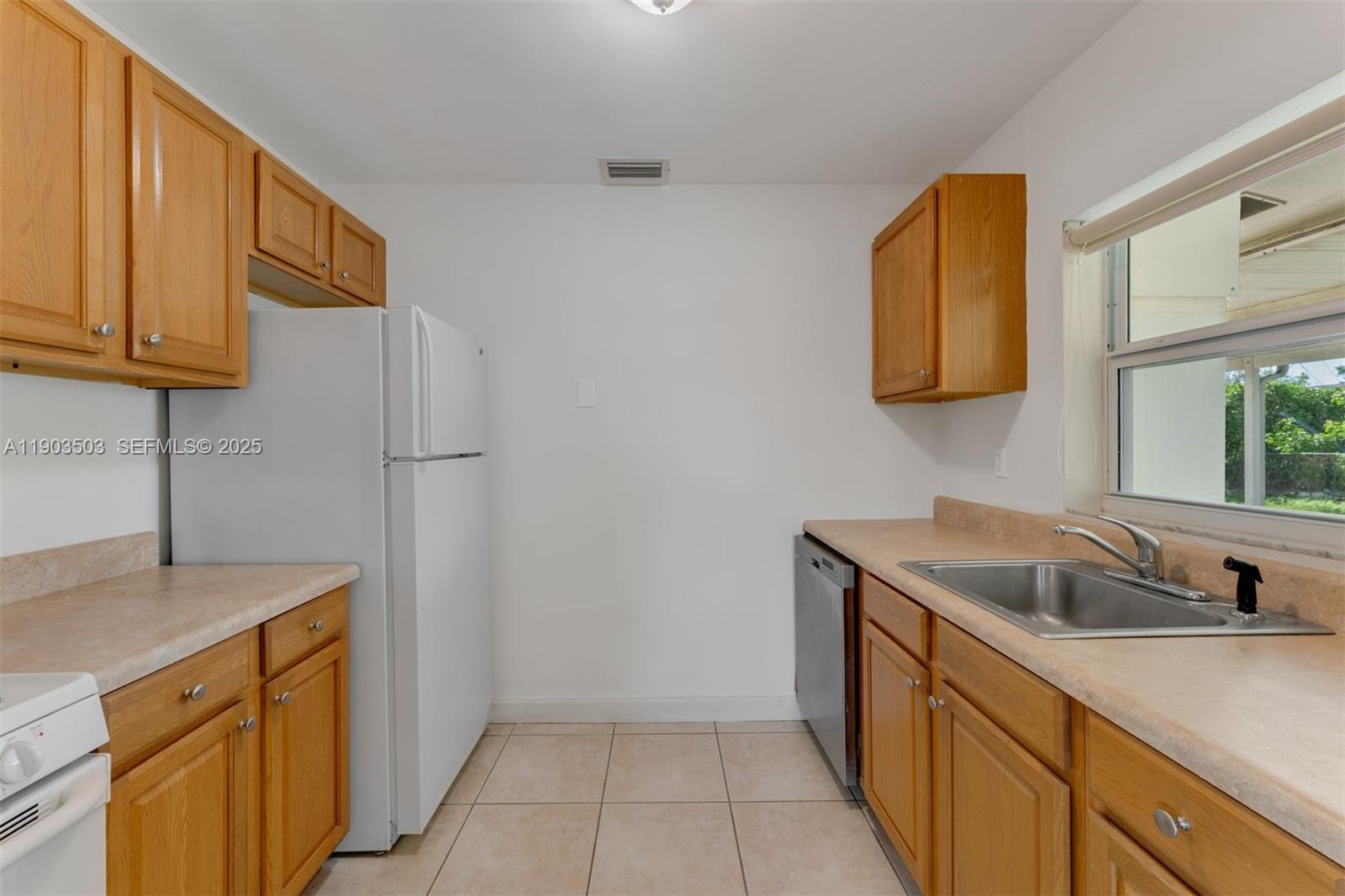 8670 Southwest 27th Lane Miami, FL 33155 - Photo 15 of 31 a kitchen with a sink and a cabinets