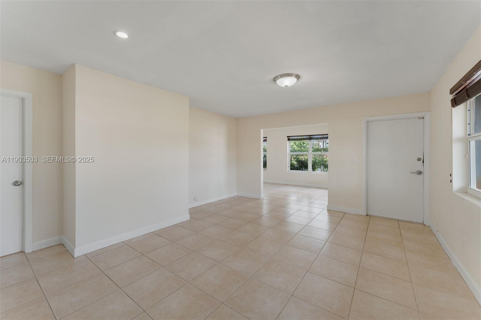8670 Southwest 27th Lane Miami, FL 33155 - Photo 19 of 31 an empty room with kitchen view and windows