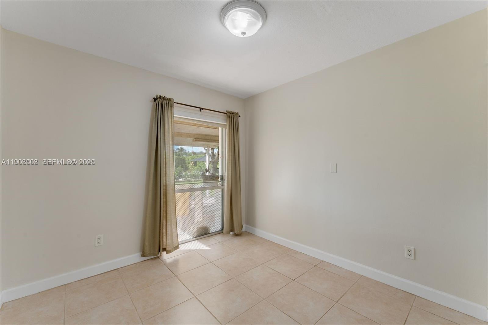 8670 Southwest 27th Lane Miami, FL 33155 - Photo 20 of 31 an empty room with closet and windows