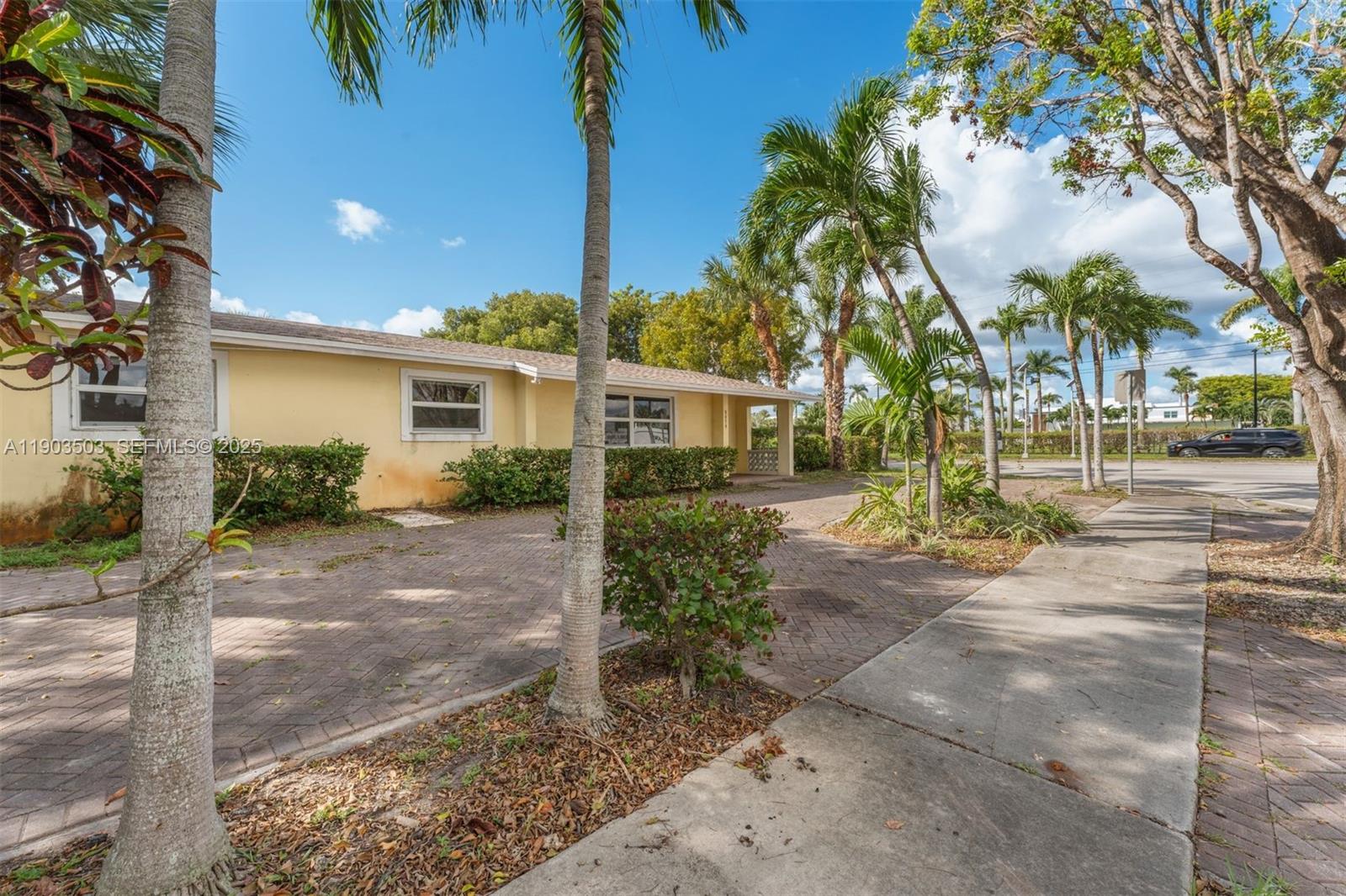 8670 Southwest 27th Lane Miami, FL 33155 - Photo 2 of 31 a view of a yard with plants and palm trees