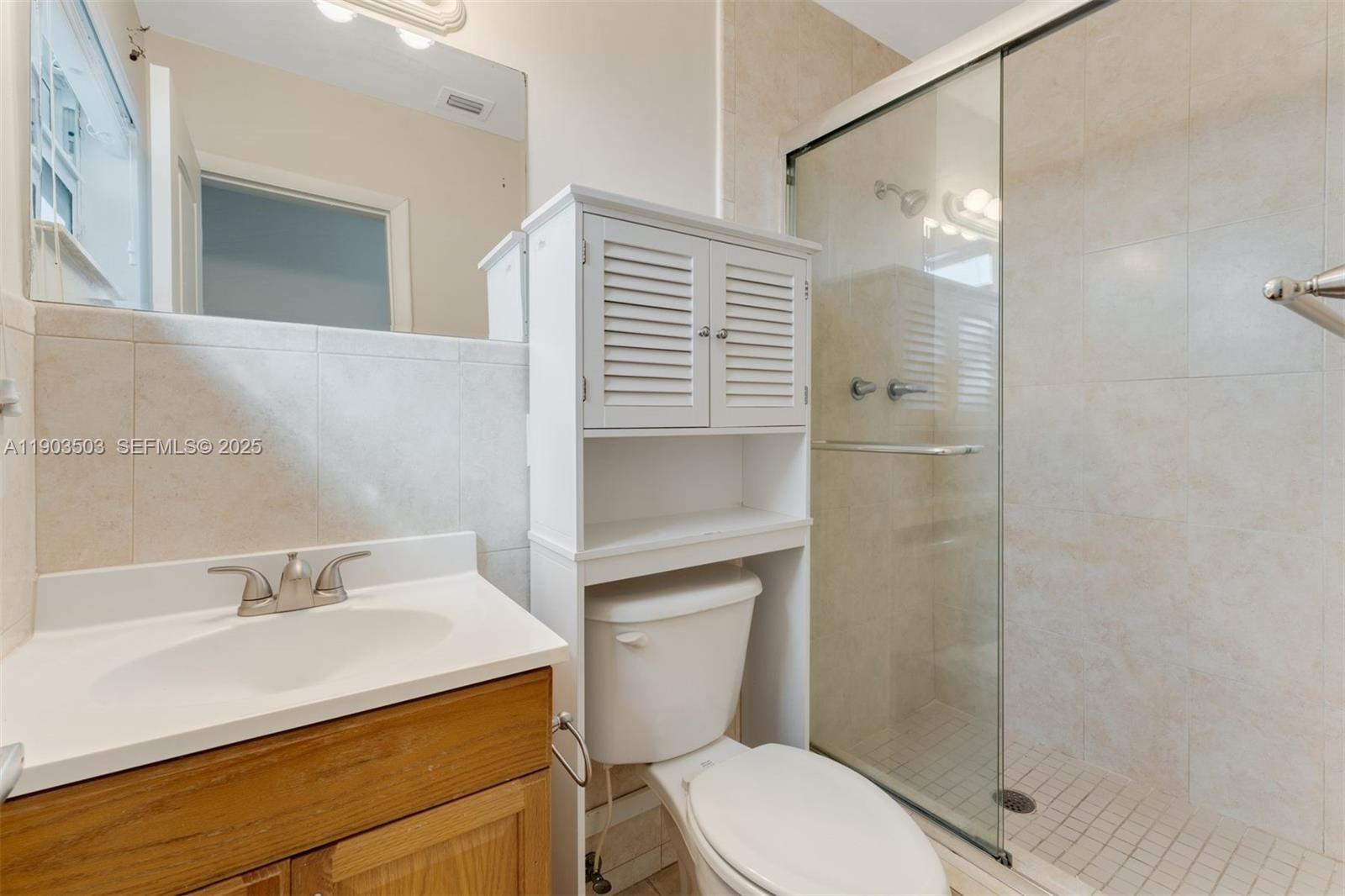 8670 Southwest 27th Lane Miami, FL 33155 - Photo 27 of 31 a bathroom with a sink toilet and shower