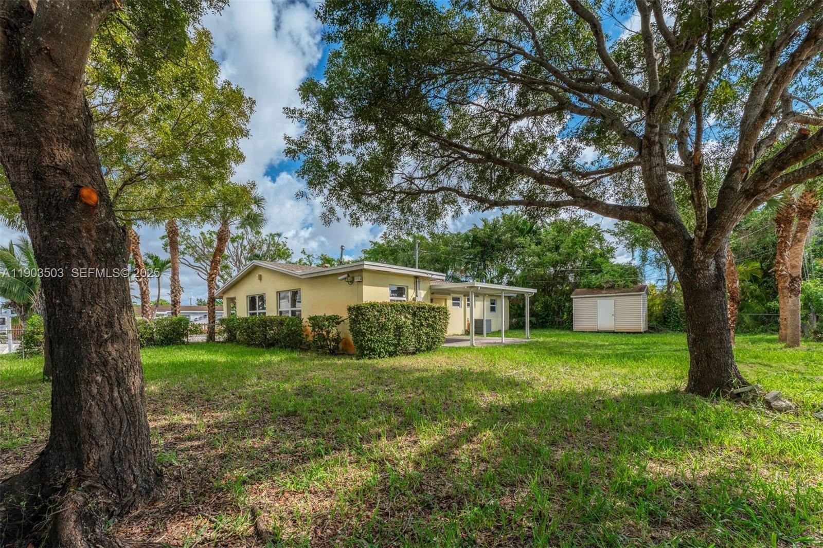 8670 Southwest 27th Lane Miami, FL 33155 - Photo 7 of 31 a house with a tree in front of a white house