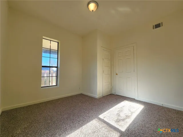 a view of an empty room and window